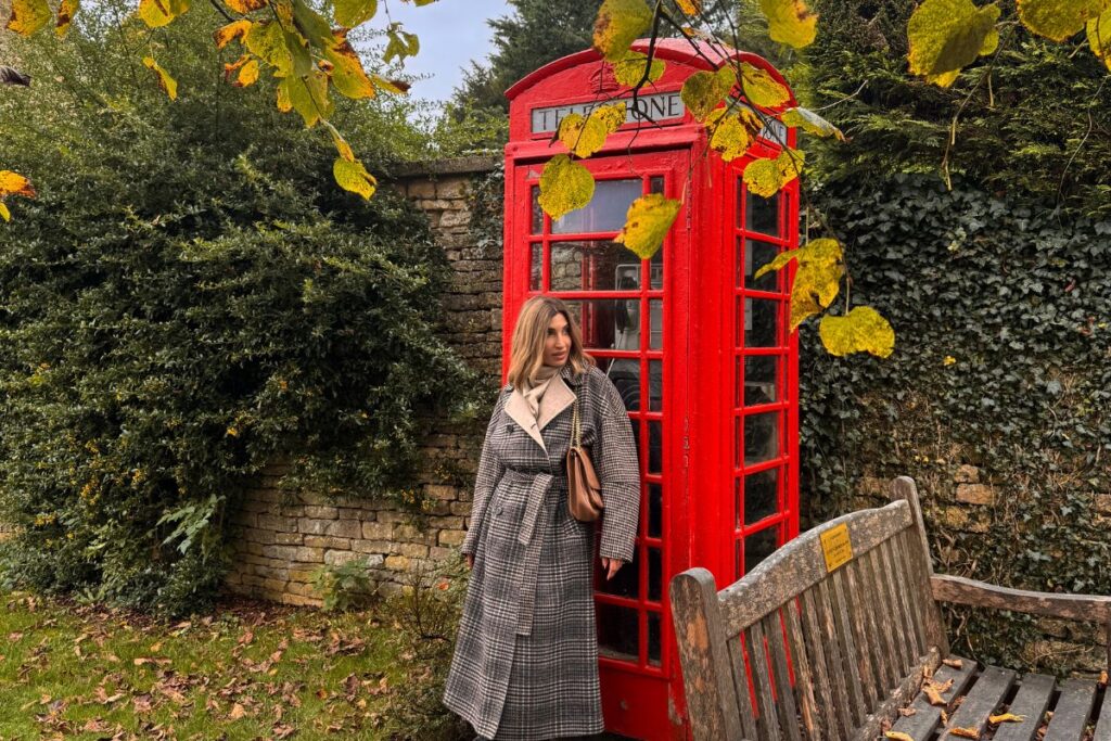 Cabina rossa tra le foglie d’autunno nelle Cotswolds